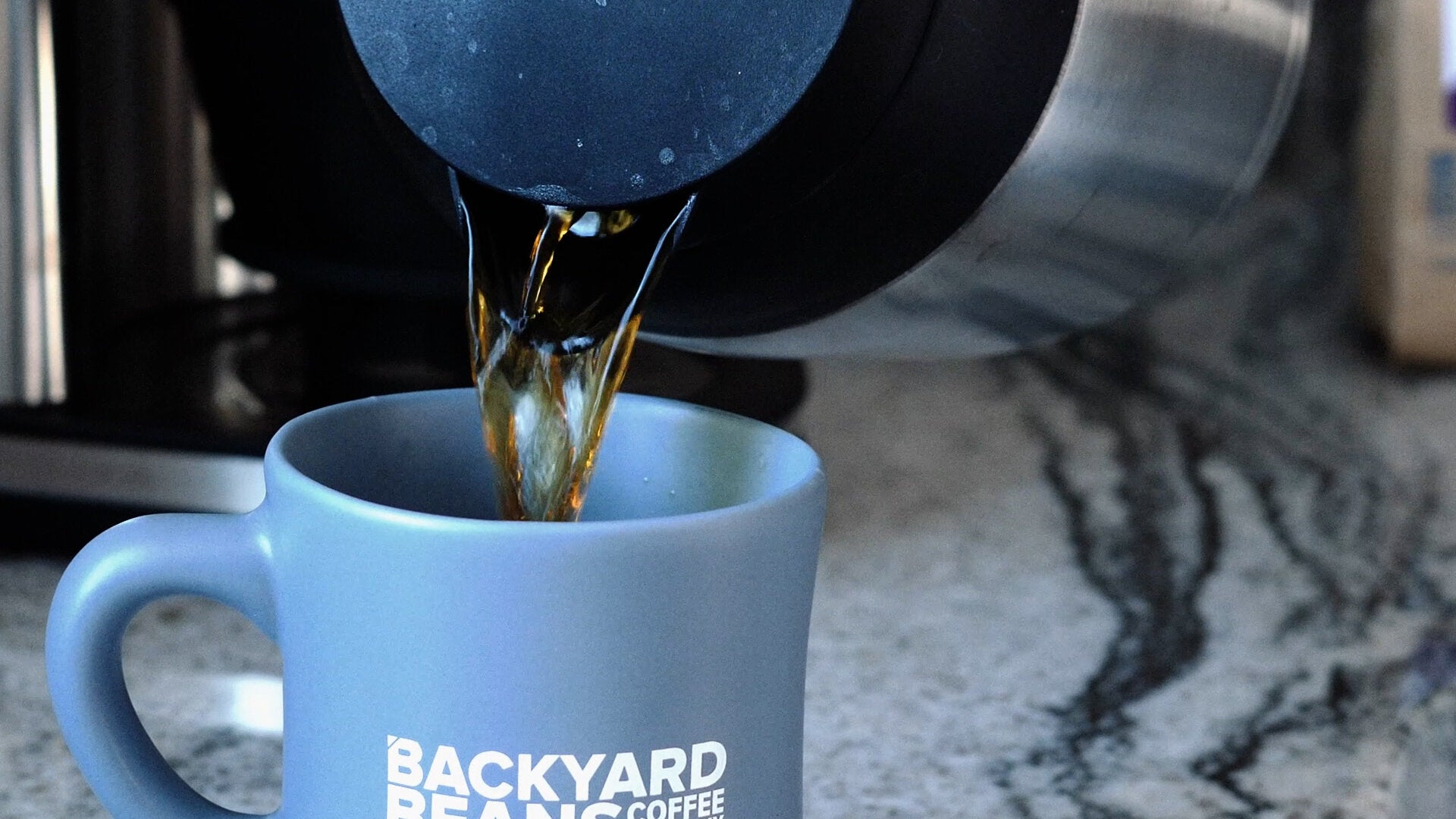 Image of coffee pouring into mug.