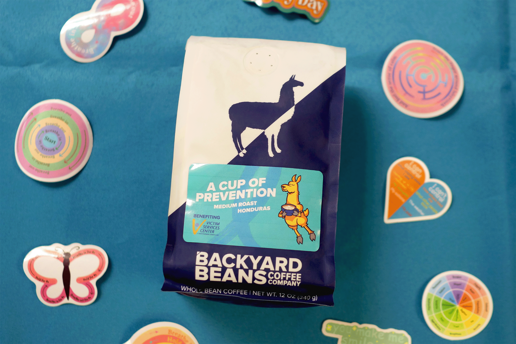 Image of A Cup of Prevention coffee bad with stickers and blue background