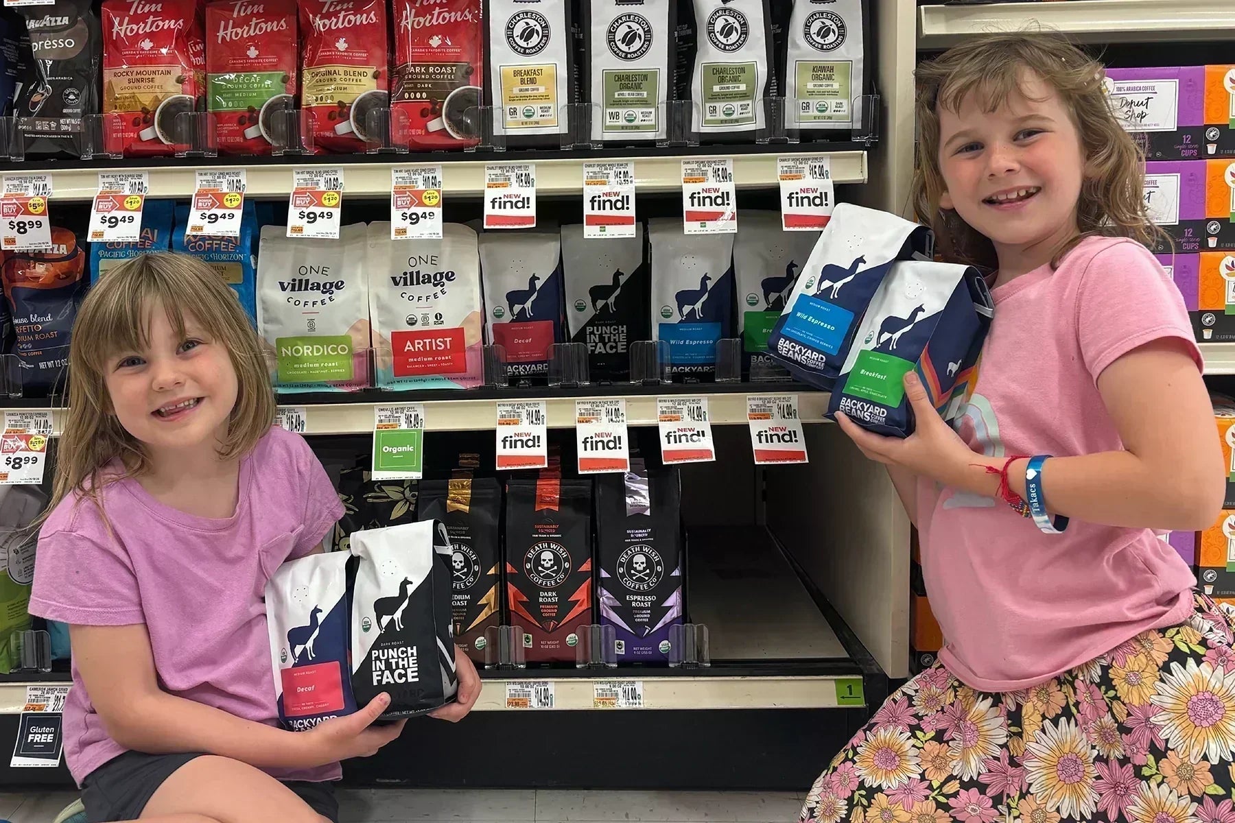 Image of two children holding Backyard Beans retail bags at Giant grocery stores