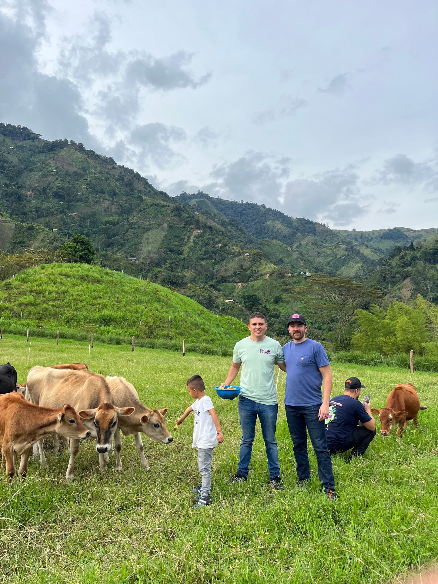 Image of Emmanuel Enciso with Bobby Wrigley in the cows pasture next to the washing station.