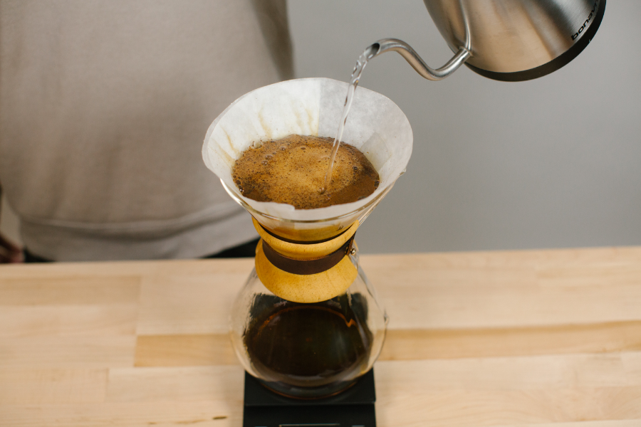 Image of wetting coffee grounds in a Chemex.