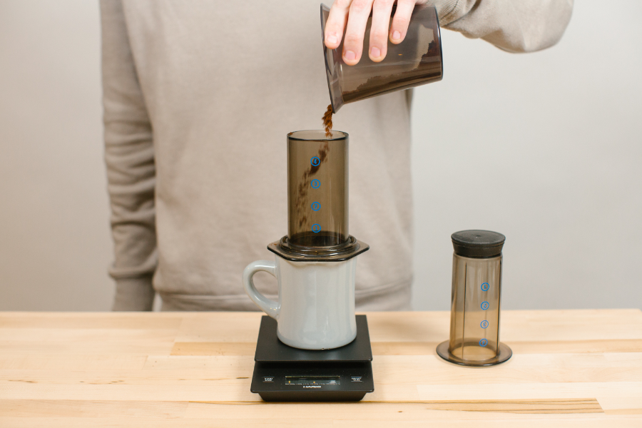 Image of coffee grounds going into Aeropress.