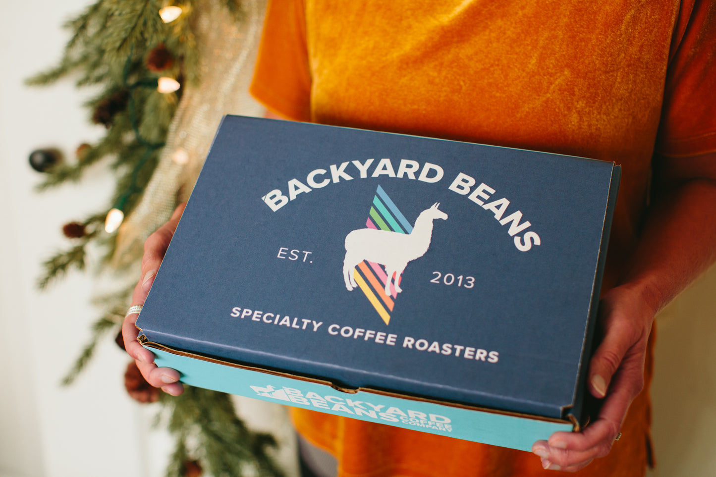 Image of woman's hands holding gift box.