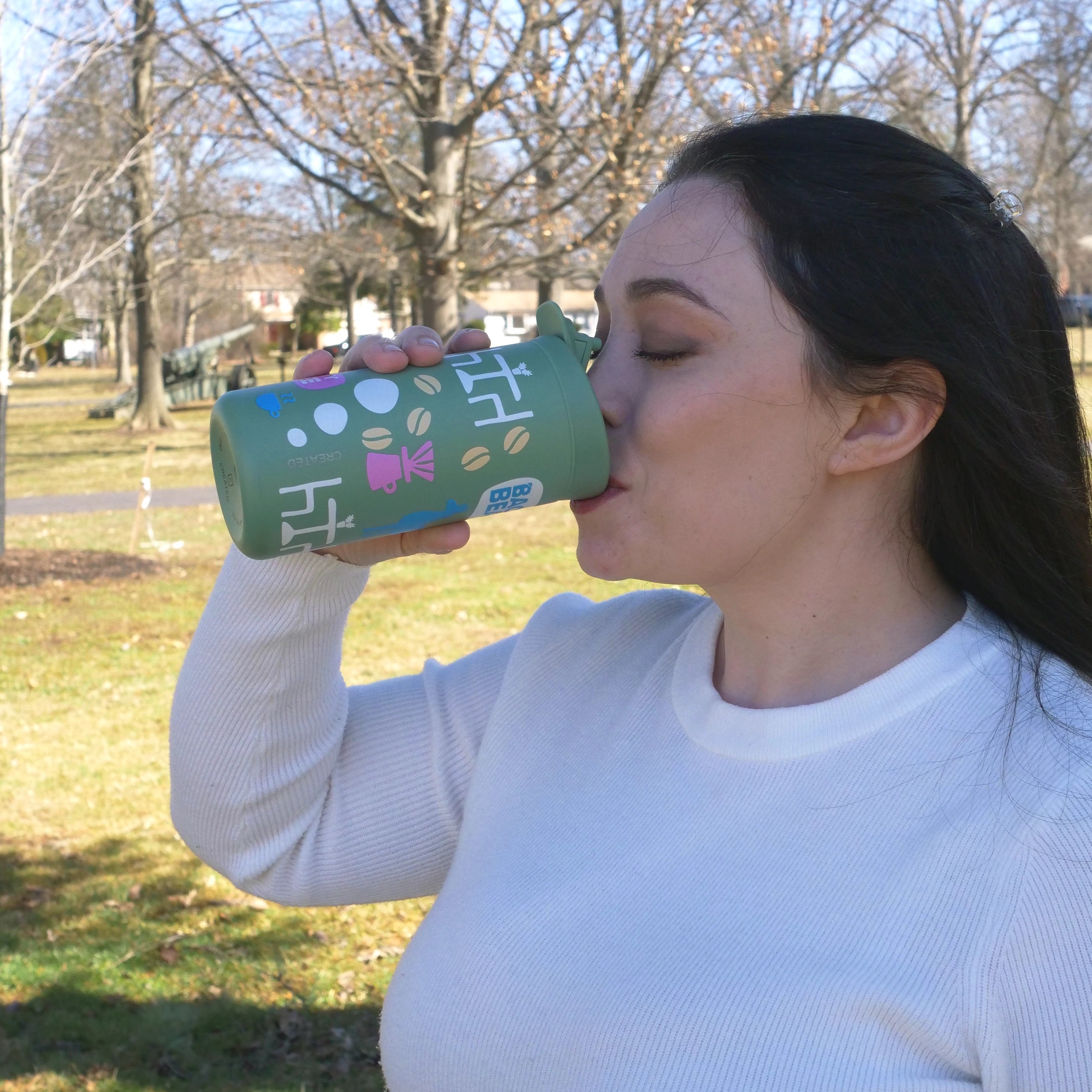Image of woman drinking from Backyard Beans limited edition spring hot cup