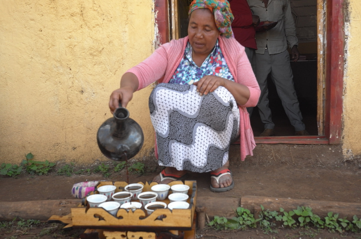 image of a woman serving a coffee ceremony at Yukro station