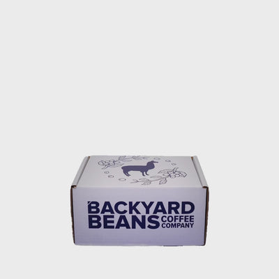 short stop motion video showing the backyard beans gift box including 2 retail 12oz coffee bags and backyard beans branded mug